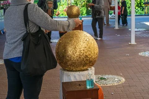 Devotee gilding temple sphere Stock Photos