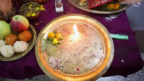 Devotee hand worshiping aarti after traditional pooja offerings at indoors on Video stock 335121590