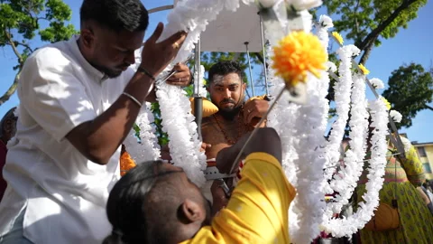 The devotee has secured a kavadi onto their body during the Thaipusam festival. Stock Footage 234047237