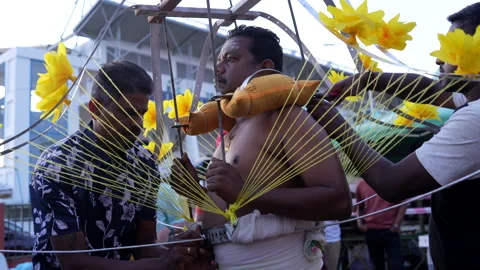 The devotee has secured a kavadi onto their body during the Thaipusam festival. Stock Footage 234385348