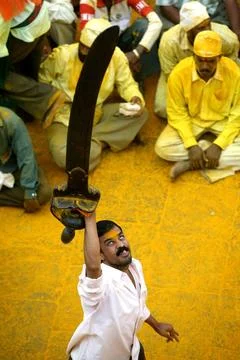 A devotee with historical sword weighing around 40 kg in his hands paying ... Stock Photos
