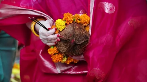 Devotee with holy offerings during sacred chhath puja ritual at outdoor Stock Footage 316803493