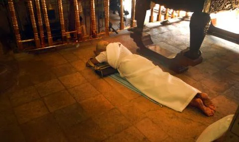 Devotee lying down in front of the temple Stock Photos