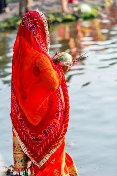Devotee offering prayers to God During Chhath Puja Festival Stock Photos
