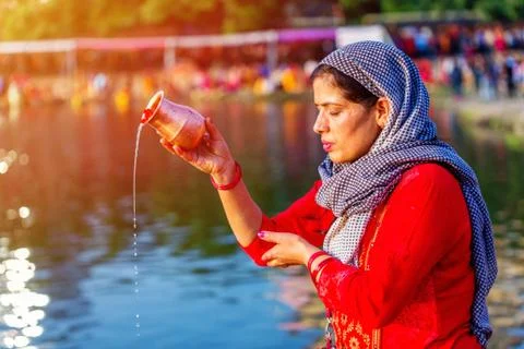 Devotee offering prayers to God During Chhath Puja Festival Stock Photos