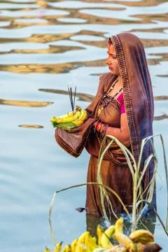 Devotee offering prayers to God During Chhath Puja Festival Stock Photos