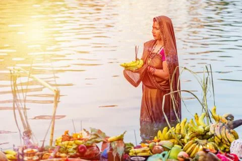 Devotee offering prayers to God During Chhath Puja Festival Stock Photos