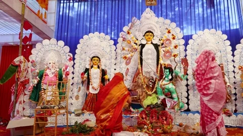 Devotee offering prayers to goddess durga idol during dussehra in daylight Stock Footage 314781715