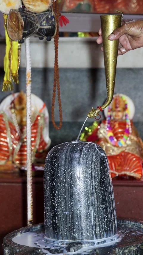 Devotee Performing Milk Abhishek On Lord Shiva Lingam During Hindu Worship .. Stock Footage 340087936