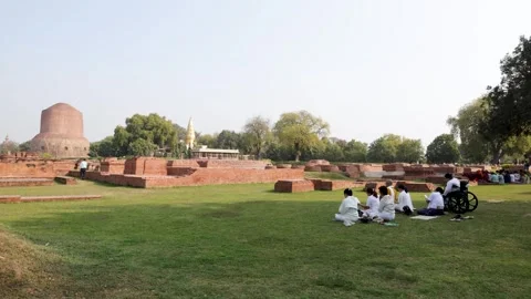 Devotee performing ritual at sarnath buddhist dhamek stupa Stock Footage 316037904