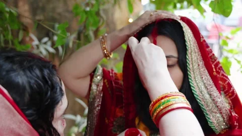 Devotee performing sacred sindoor or vermilion rituals on chhath puja Stock Footage 316803370