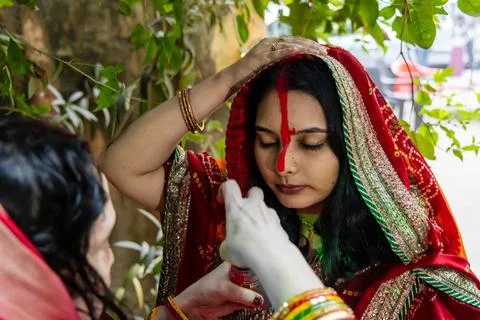 Devotee performing sacred sindoor or vermilion rituals on chhath puja celeb.. Stock Photos