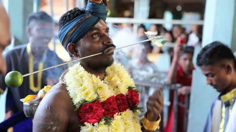Devotee with pierced cheeks at Batu Caves temple during Thaipusam Hindu Festival Stock Footage 41673998