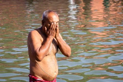Devotee praying after bathing in holy river water at morning from flat angle Stock Photos