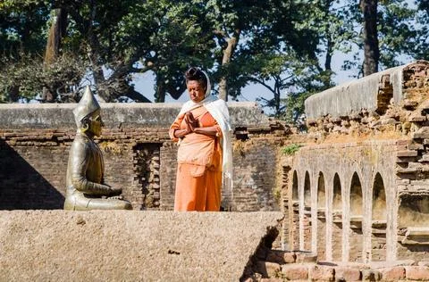Devotee praying to an image of a saint in the hills above Pashupatinath Te... Stock Photos