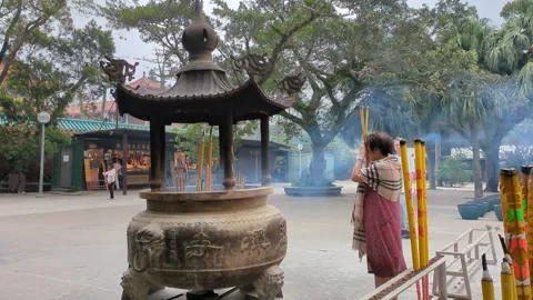 Devotee praying at Po Lin monastery Hong Kong. Slow motion, 4k. Stock Footage 271235319