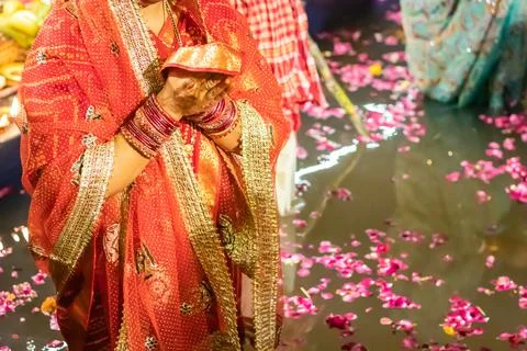 Devotee praying for sun god during Chhath festival from flat angle 写真素材