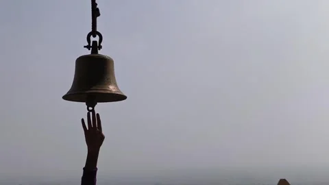 Devotee Ringing Temple Bell During Prayer in Karnataka Stock Footage 324840229