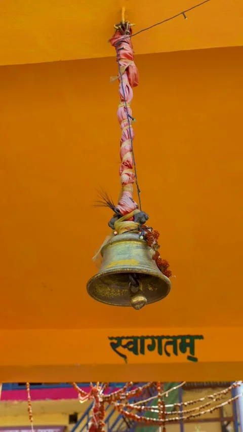 Devotee ringing traditional brass bell at Rudranath Temple Stock Footage 346275381
