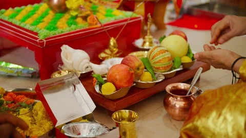 Devotee sets dishes on the decorated platform for ritual Stock Footage 303126379