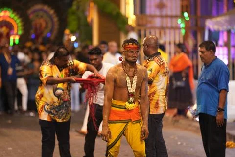 Devotee undergoes ritual preparation under supervision before participating i Foto stock