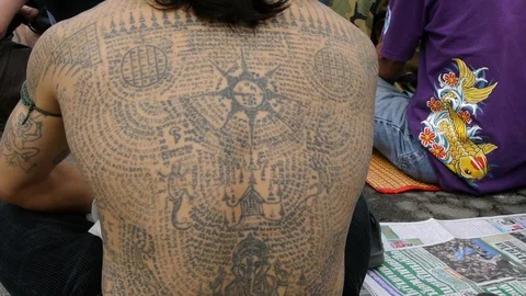 A devotee at Wat Bang Phra covered in sacred tattoos. Video stock 121073345