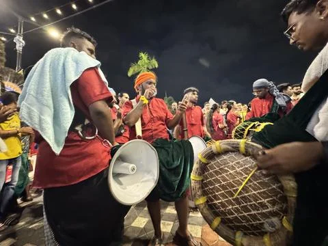 Devotees and drummers coordinate rhythms during Thaipusam Stock Photos