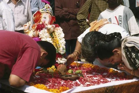 Devotees bowing down in front of Lord Ganesh ganpati Festival Elephant hea... Stock Photos