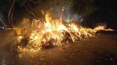 Devotees burn joss paper as a sacred offering during grand ritual 動画素材 318100918