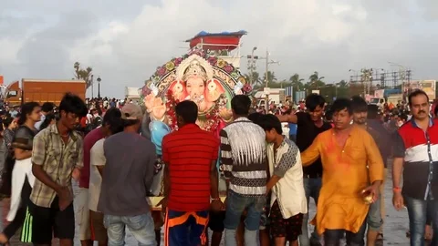Devotees carrying an idol of elephant headed Hindu god Ganesh Stock Footage 79556149