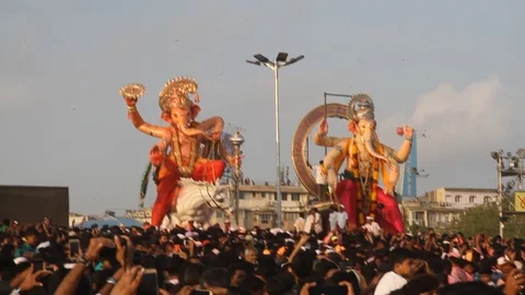 Devotees carrying idols of elephant headed Hindu god Ganesh Stock Footage 95490999