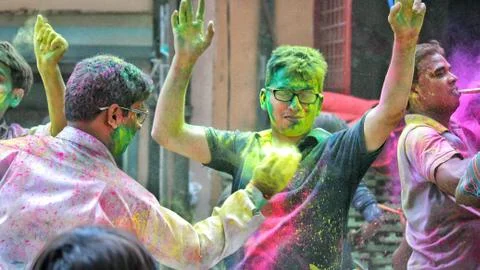 Devotees dancing to bid adieu to Lord Ganesha in Delhi during Ganesh Visarjan Stock Photos