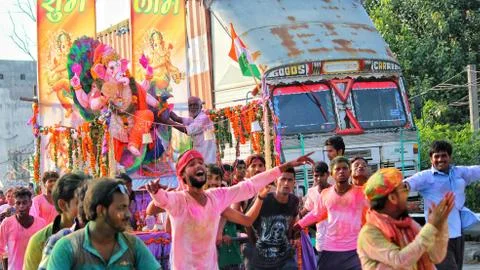 Devotees dancing to bid adieu to Lord Ganesha in Delhi during Ganesh Visarjan Stock Photos