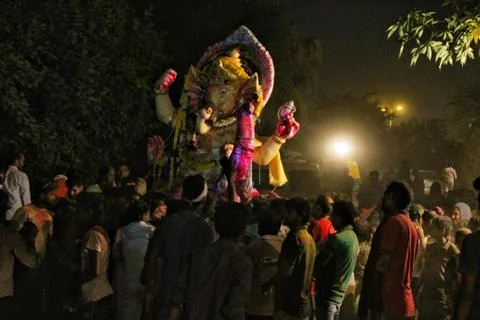 Devotees dancing to bid adieu to Lord Ganesha in Delhi during Ganesh Visarjan Stock Photos