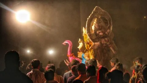 Devotees dancing to bid adieu to Lord Ganesha in Delhi during Ganesh Visarjan Stock Photos
