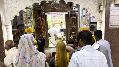 Devotees entering temple sanctum for darshan inside decorated hindu shrine hall Stockbeeldmateriaal 331150048