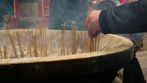 Devotees offering incense sticks outside the temple Stock Footage 88677677