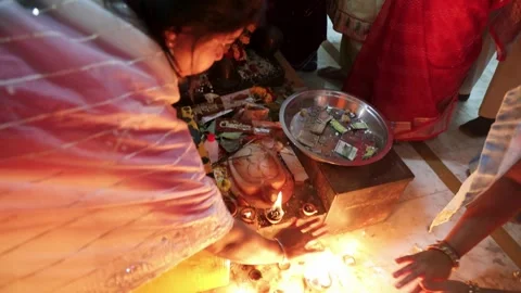 Devotees offering prayers to decorated nandi statue inside temple Stock Footage 321880069