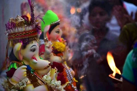 Devotees perform pooja before carrying an idol of elephant headed Hindu go... Stock Photos