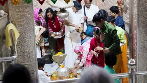 Devotees performing abhishekam to shivling with offerings and flowers in temple Stock Footage 321880115