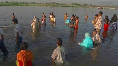 Devotees performing holy dip and prayers in Yamuna river Stock Footage 341109687