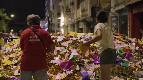 Devotees Piling Joss Paper Offerings on Street at Night during Hungry Ghost Stock Footage 346255596
