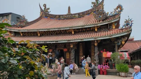 Devotees praying at Dalongdong Baoan Temple in Taipei Stock Footage 267523778