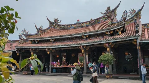 Devotees praying at Dalongdong Baoan Temple in Taipei Stock Footage 267562266
