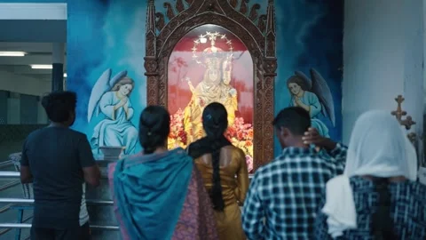 Devotees Praying Before Golden Virgin Mary Statue in Ornate Church Shrine Stockbeeldmateriaal 339850105
