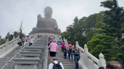 Devotees praying their gratitude during climbing Big Buddha Hong Kong Stock Footage 273190807