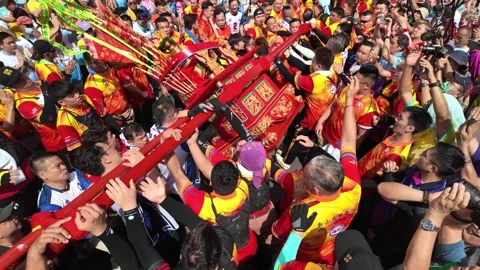 Devotees shaking ritual floats of deities on palanquins during the Johor Stock Footage 302803084