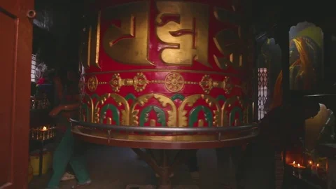 Devotees spinning the huge prayer wheel in the temple of Kathmandu Stock Footage 77446793