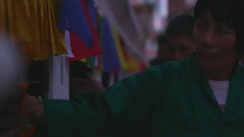 Devotees spinning prayer wheels outside a Tibetan Buddhist temple in Kathmandu Stock Footage 77453480