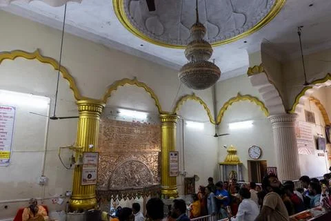 Devotees standing in queue for darshan inside crowded hindu temple hall Stock Photos